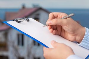 Hand-signing-document-clipboard-home