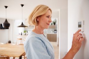 woman-using-thermostat