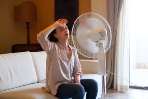 woman-sitting-on-couch-in-front-of-fan