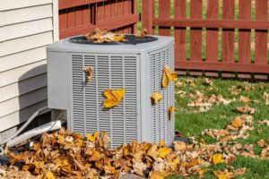 fall-leaves-around-ac-outdoor-unit