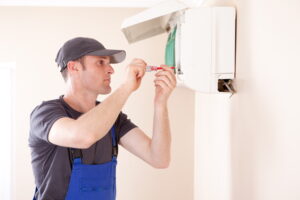 Air conditioner technician installing mini split